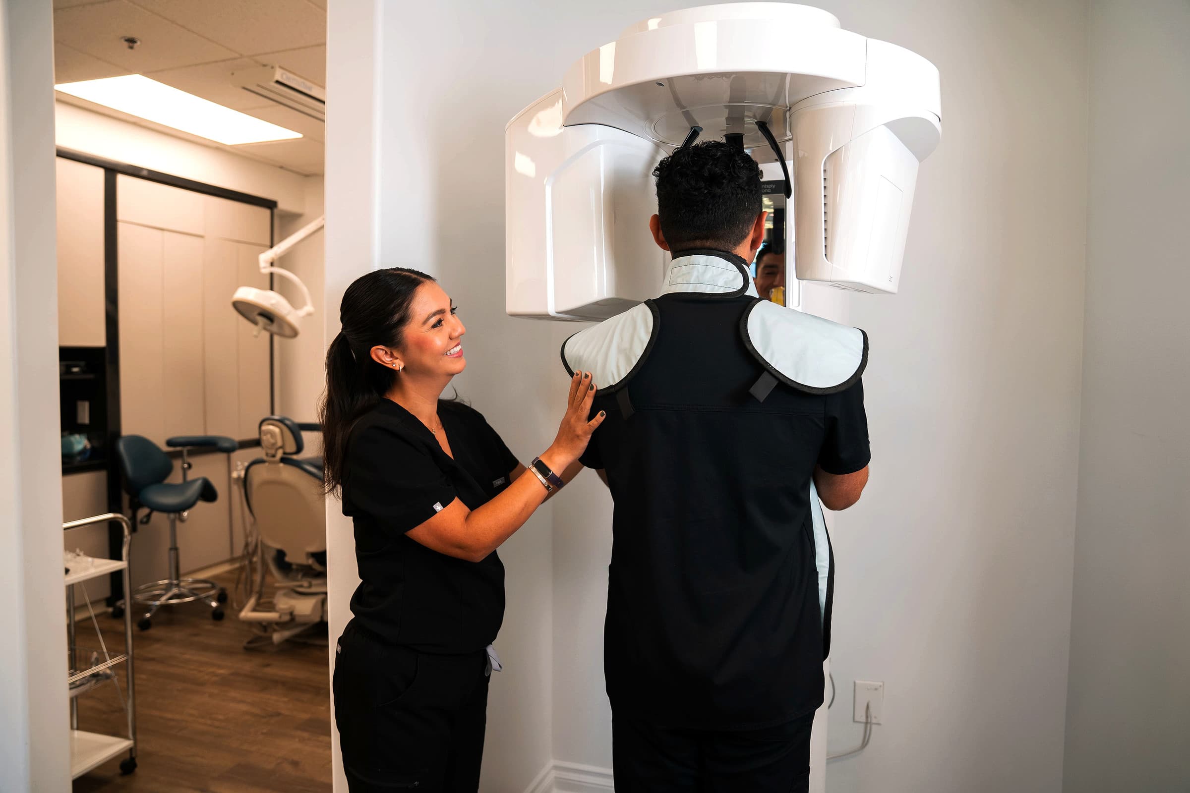 Dental professional assisting a patient with advanced imaging technology in a modern dental practice, emphasizing personalized care and innovative treatments at SoCal Prime Dentistry.