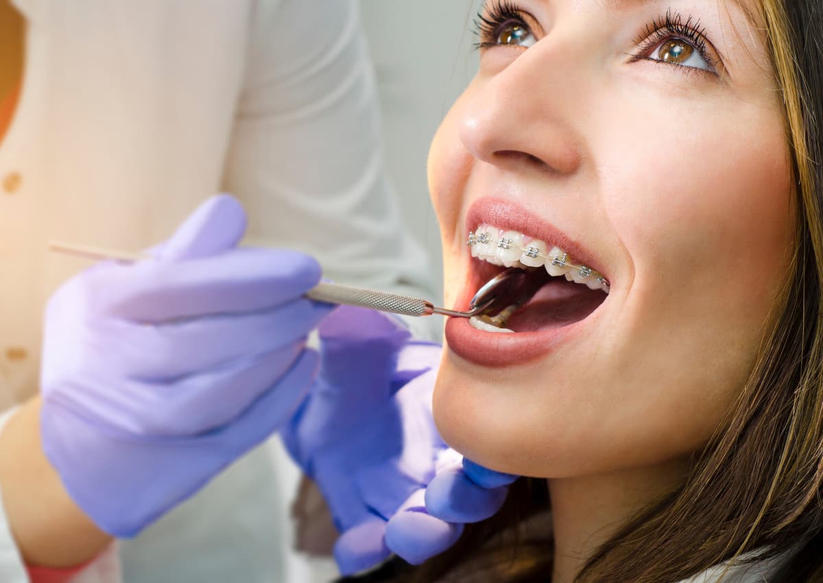 Patient receiving dental care with orthodontic tools, emphasizing comfort and professional service at SoCal Prime Dentistry.