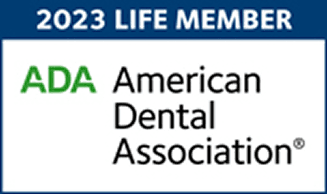 2023 Life Member badge of the American Dental Association (ADA) highlighting Dr. Mayank Sharma's professional recognition in dentistry.