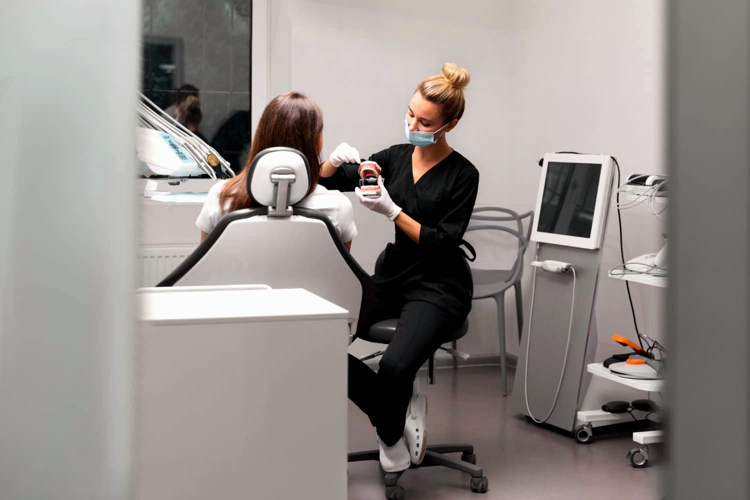Dental professional in a modern clinic setting, emphasizing comfort and patient care at SoCal Prime Dentistry in Rancho Santa Margarita.
